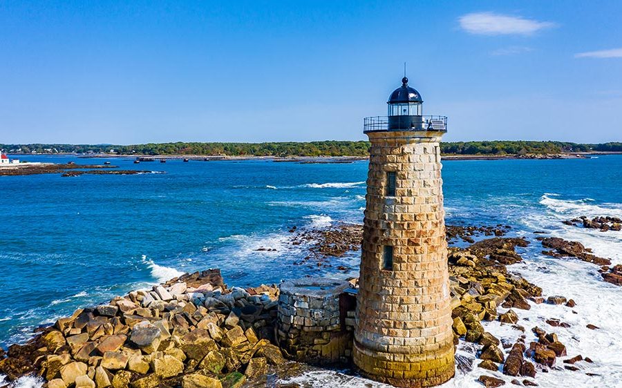 The Whaleback Lighthouse in Kittery, Maine, with the red-roofed Wood Island Life Saving Station in the background