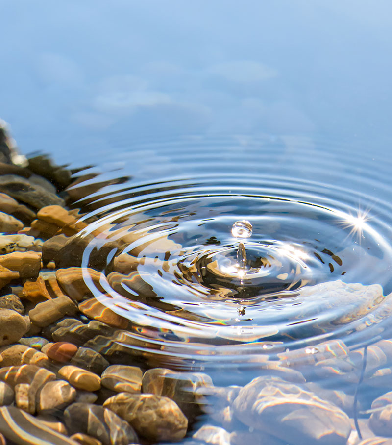 Economic and fiscal impact analysis visualized as the ripple effect of a drop of water in a pond