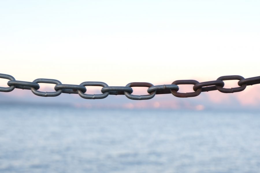 A chain made of multiple metal links across a body of water