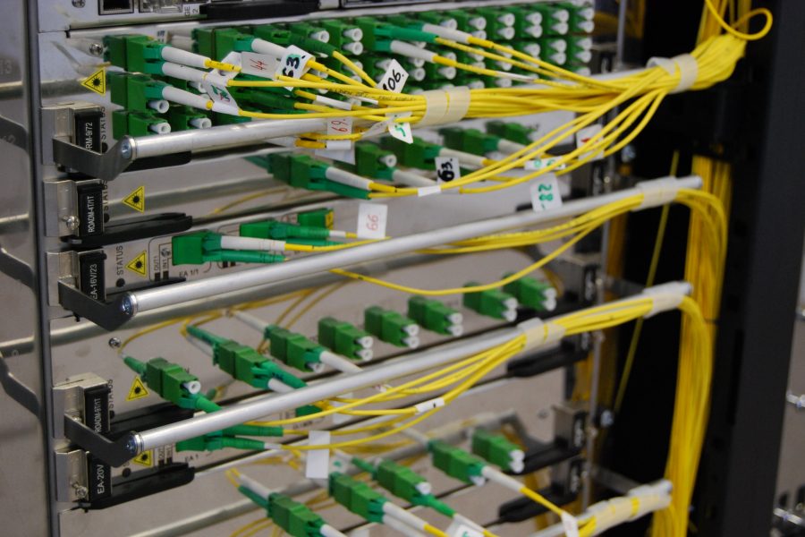 Yellow and green wires connect server components in a data center