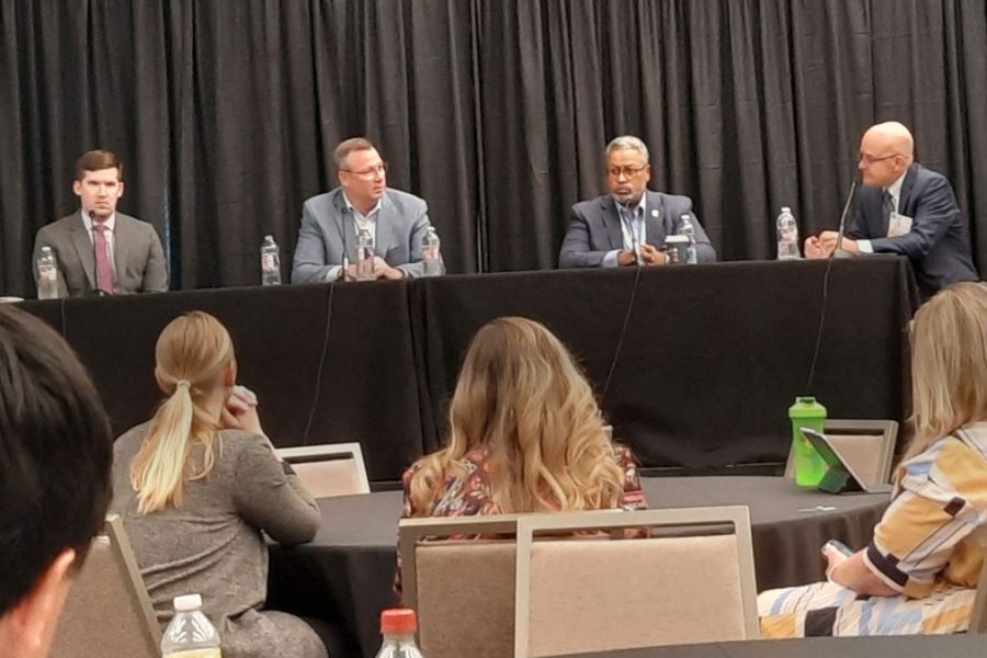 The three panel members at the conference session, Kenny McDonald, President and CEO of One Columbus, Craig Richard, President and CEO of the Tampa Bay Economic Development Council, Jeff Seymour, Executive Vice President of the Greater Oklahoma City Chamber, and the moderator Dan Gundersen from Camoin Associates sit at a table facing audience members.