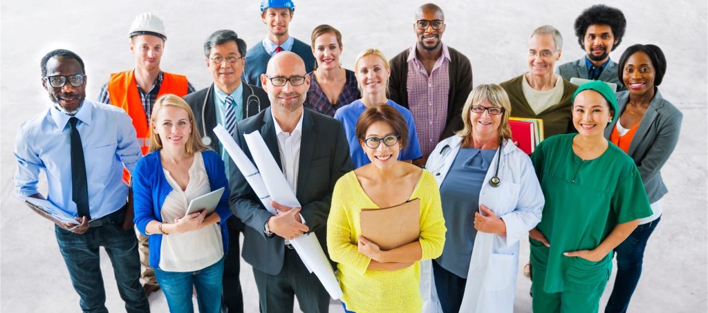 A diverse group of many different types of people working in different professions, including professional services, engineering, construction, healthcare, maintenance, and administrative.