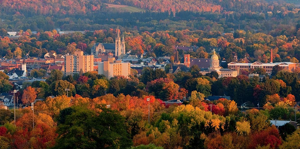 Aerial photo of the City of Cortland in Central New York State surrounded by beautiful trees in the fall