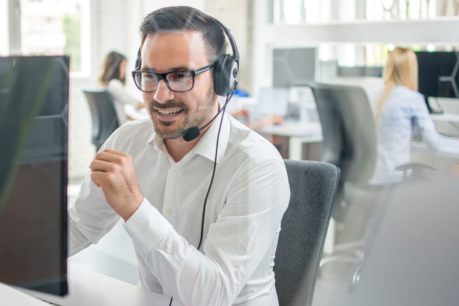 Call center worker speaks to a business prospect on the phone