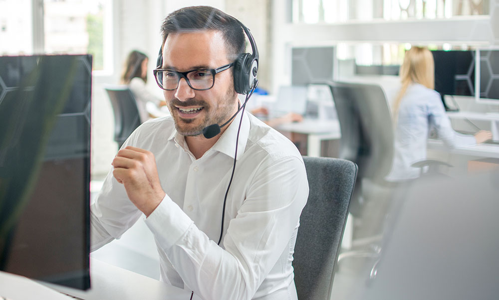 Call center worker speaks to a business prospect on the phone