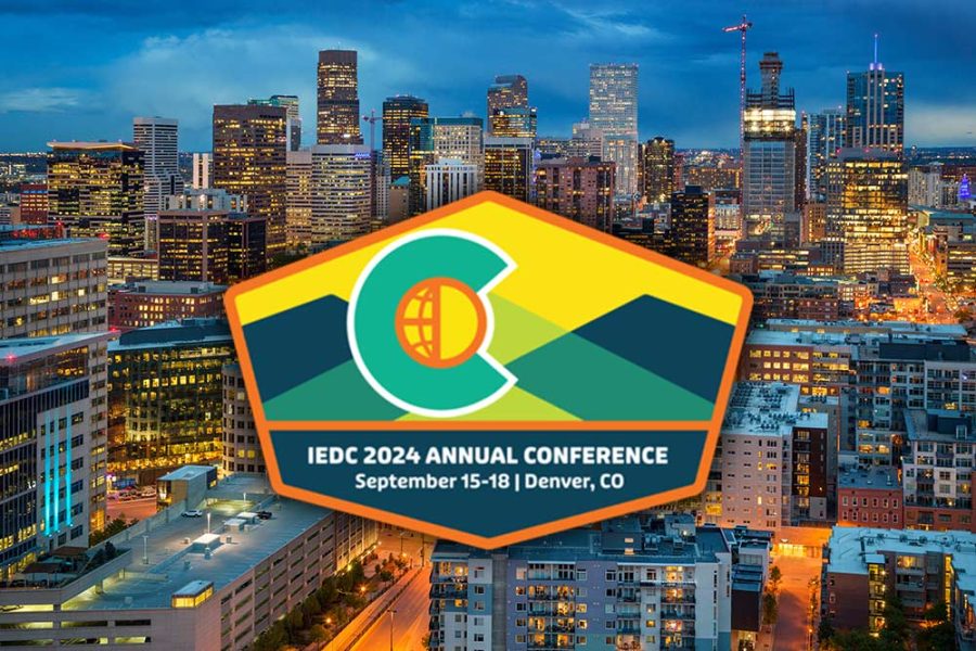 The International Economic Development Council's logo for its 2024 Annual Conference over the top of a photo of downtown Denver.