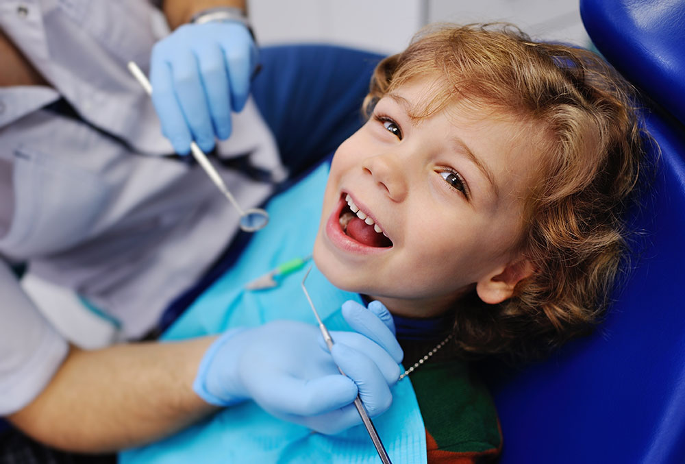 A smiling child being examined at a dentist illustrates successfully filling the retail vacancies.