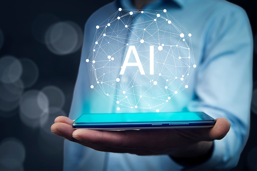 A man in a light blue button-down shirt holds a smart phone in his open palm with "AI" floating above it along with other related technology symbols