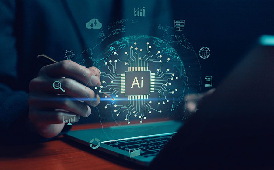 A person wearing a suit sits in front of a laptop computer. An image of a computer chip with 