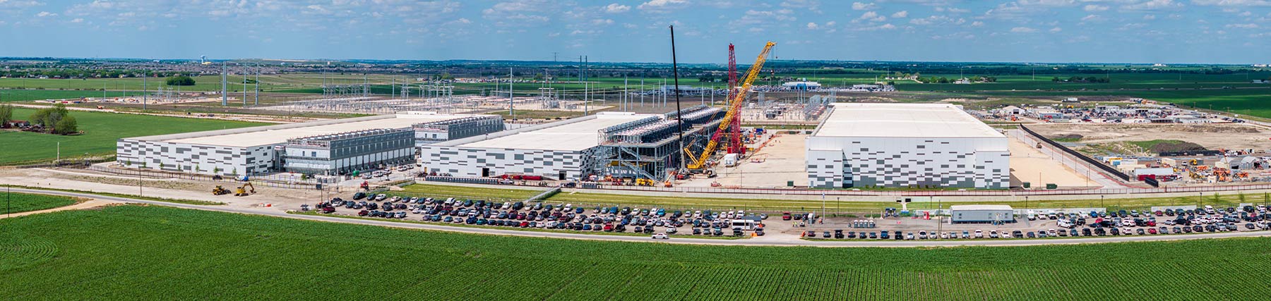 A massive data center in Hutto, Texas, with multiple structures and several construction cranes around one unfinished building